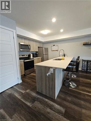 Kitchener townhouse for rent - A kitchen with a white counter top and a wooden floor.