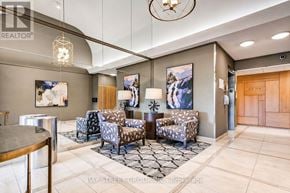 Toronto (Willowdale East) condo for rent - A well-lit lobby with a glass table and chairs.