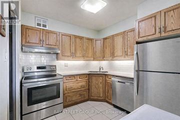Toronto (Willowdale East) condo for rent - A kitchen with wooden cabinets and stainless steel appliances.