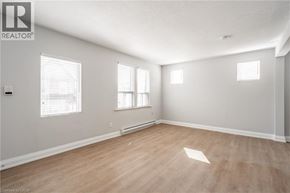 Hamilton apartment for rent - A room with wooden flooring and white walls.