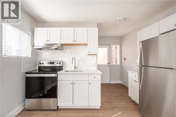 Hamilton apartment for rent - A kitchen with white cabinets and stainless steel appliances.