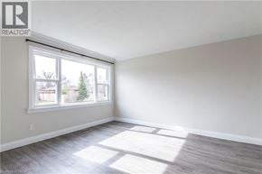 Burlington apartment for rent - A room with a large window and a wooden floor.