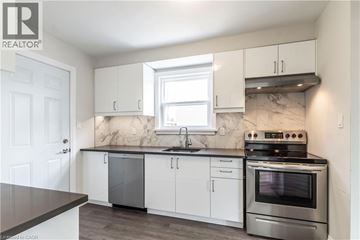Burlington apartment for rent - A kitchen with white cabinets and a marble backsplash.