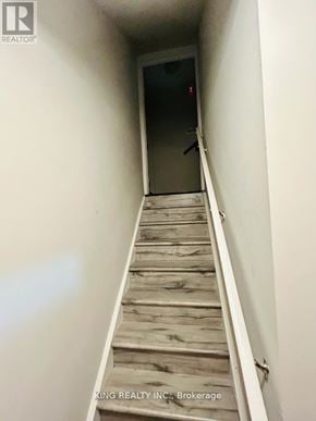 Brampton (Credit Valley) apartment for rent - A staircase with wooden steps leading to a door.