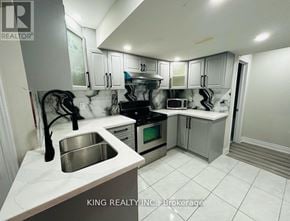 Brampton (Credit Valley) apartment for rent - A kitchen with a sink, stove, and cabinets.