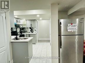 Brampton (Credit Valley) apartment for rent - A kitchen with a refrigerator that has a sign on it.