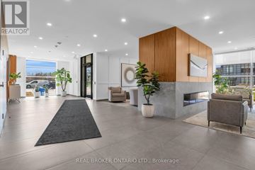 Guelph (Pineridge/Westminster Woods) condo for rent - A modern living room with a black rug and a wooden cabinet.