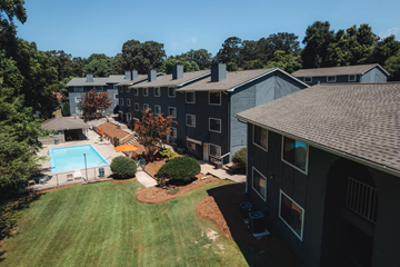 Gainesville apartment for rent - A view of a residential area with houses and a swimming pool.