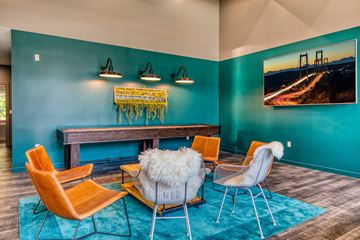 Lakewood apartment for rent - A living room with a blue wall and a painting of a bridge.