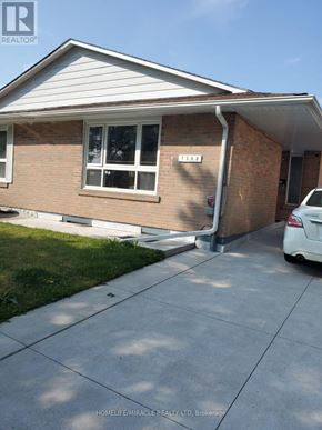Mississauga (Malton) apartment for rent - A house with a white car parked in front.