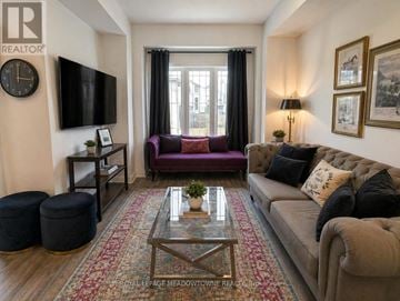 Hamilton townhouse for rent - A living room with a purple couch and a coffee table.