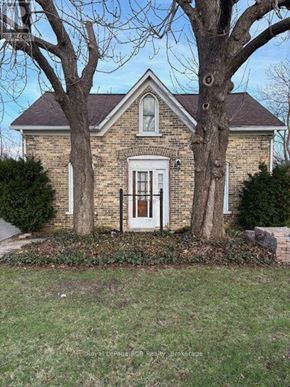 Kincardine apartment for rent - A house with a white door and a tree in front.