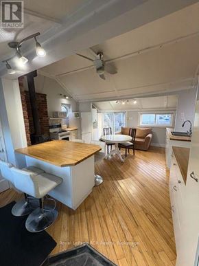 Kincardine apartment for rent - A room with a wooden floor and a ceiling fan.
