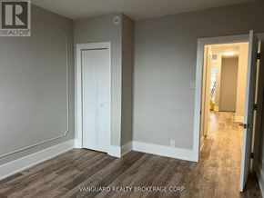 Toronto (Oakwood Village) townhouse for rent - A room with a white door and a wooden floor.