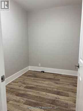 Toronto (Oakwood Village) townhouse for rent - A room with wood flooring and white walls.