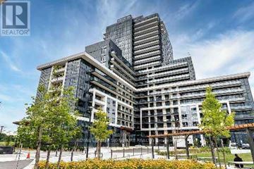 Oakville (Jm Joshua Meadows) condo for rent - A modern multi-story building with a glass facade and a landscaped area in front.