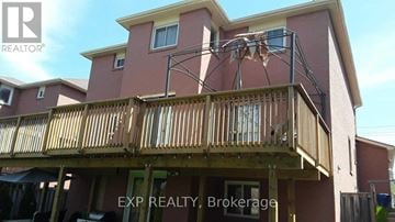 Ajax (Central) apartment for rent - A house with a balcony and a sign that says EXP REALTY Brokerage.
