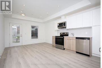 Toronto (L'amoreaux) townhouse for rent - A modern kitchen with wooden floors and stainless steel appliances.