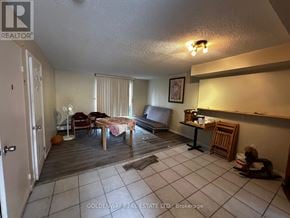Toronto (Black Creek) townhouse for rent - A living room with a couch, chairs, and a dining table.