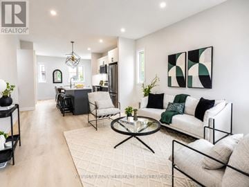 London North (North C) townhouse for rent - A modern living room with a glass coffee table and a white sofa.