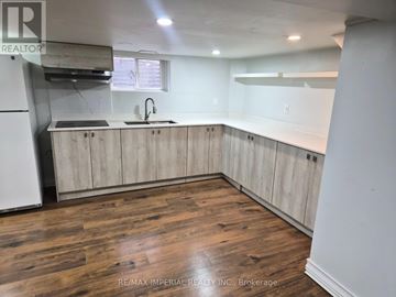 Richmond Hill (Crosby) apartment for rent - A kitchen with wooden floors and cabinets.