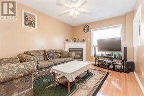 Brampton (Fletcher's Creek Village) apartment for rent - A living room with a couch, a fireplace, and a television.