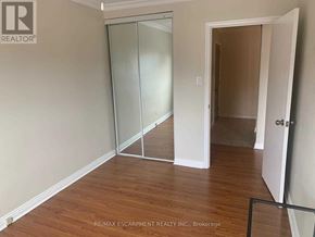 Mississauga (Port Credit) apartment for rent - A room with a glass door and wooden flooring.