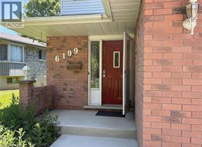 Niagara Falls apartment for rent - A red door with the number 6199 on the brick wall above it.