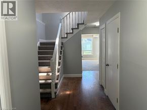 Niagara Falls apartment for rent - A hallway with a staircase and a door.