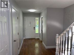 Niagara Falls apartment for rent - A hallway with a white door and a white railing.