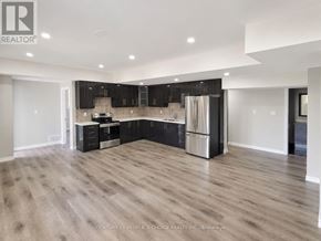 Brampton (Credit Valley) apartment for rent - A spacious kitchen with wooden flooring and modern appliances.