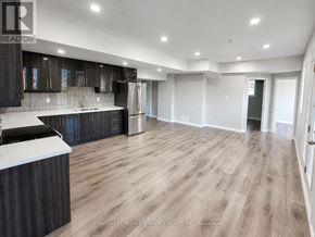 Brampton (Credit Valley) apartment for rent - A spacious kitchen with dark wood cabinets and a white countertop.