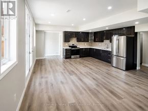 Brampton (Credit Valley) apartment for rent - A spacious kitchen with wooden flooring and modern appliances.