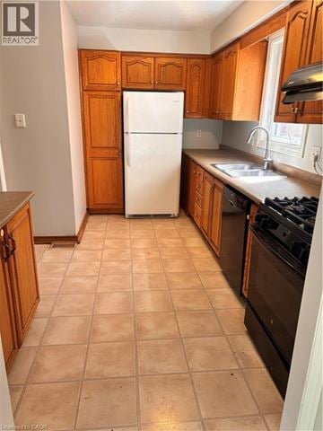 Kitchener apartment for rent - A kitchen with wooden cabinets and a white fridge.