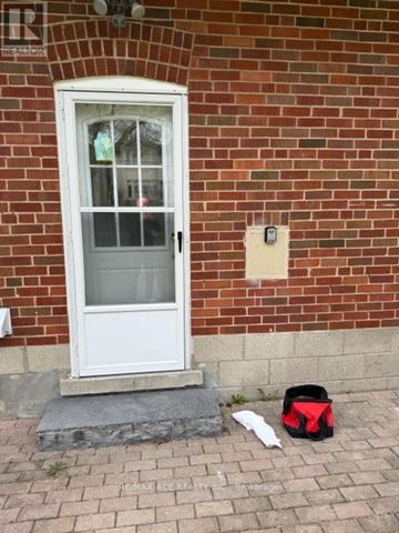 Toronto (Willowdale West) apartment for rent - A white door with a glass window is on a red brick wall.