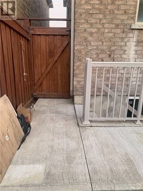 Brampton (Northwest Brampton) apartment for rent - A wooden gate is closed with a chain and padlock.