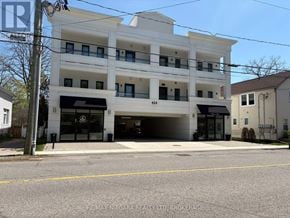 Fort Erie (Ridgeway) condo for rent - A kitchen with white cabinets and a stainless steel refrigerator.