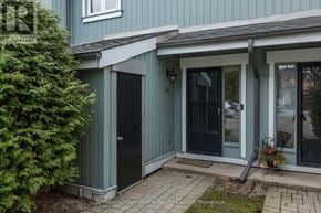 Collingwood townhouse for rent - A house with a blue exterior and a black door.