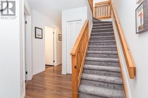 Collingwood townhouse for rent - A staircase with a wooden handrail and a carpeted runner.