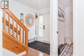 Collingwood townhouse for rent - A hallway with a staircase and a rug.