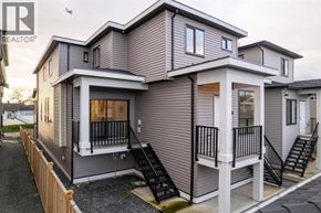 Vancouver apartment for rent - A modern two-story house with a balcony and stairs leading to the upper floor.