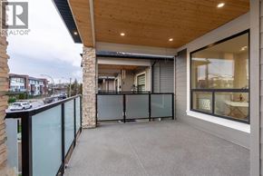 Vancouver apartment for rent - A balcony with a glass railing and a stone pillar.