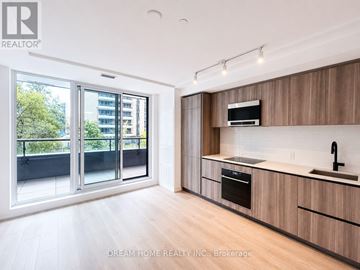 Toronto (Mount Pleasant West) condo for rent - A modern kitchen with wooden cabinets and a stainless steel oven.
