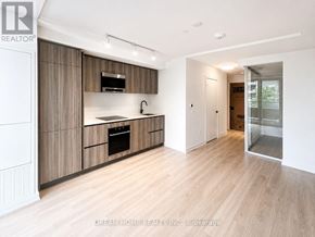 Toronto (Mount Pleasant West) condo for rent - A modern kitchen with wooden cabinets and a white countertop.