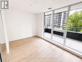 Toronto (Mount Pleasant West) condo for rent - A room with a large window and wooden flooring.