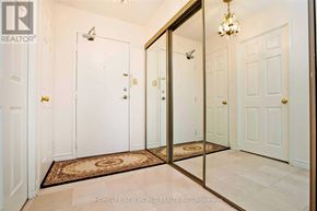 Toronto (Steeles) condo for rent - A hallway with a rug and a chandelier.