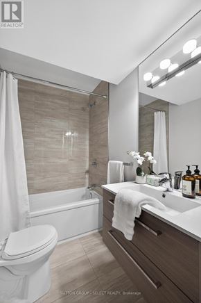 London North (North R) apartment for rent - A modern bathroom with a white toilet, a white sink, and a white shower curtain.