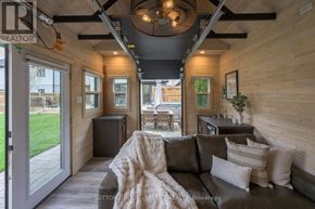 London North (North R) apartment for rent - A modern living room with a grey couch and a wooden ceiling.