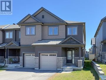 Ottawa townhouse for rent - A large, two-story house with a garage is for sale.