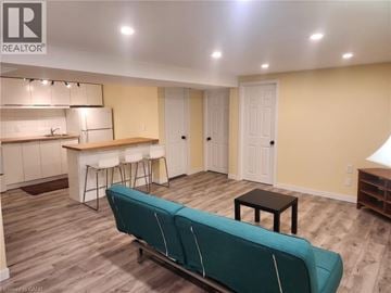 Hamilton apartment for rent - A living room with a couch and a bar area.